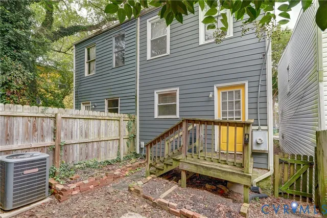 a view of a house with a wooden deck and a backyard
