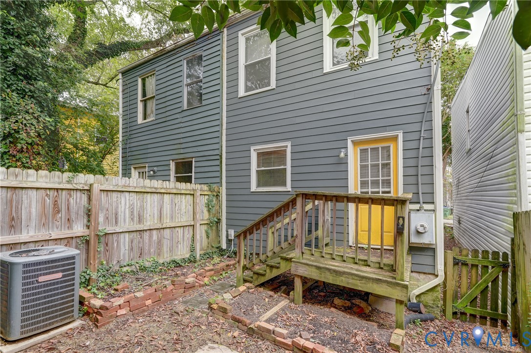818 Spring Street Richmond, VA 23220 - Photo 23 of 28 a view of a house with a wooden deck and a backyard