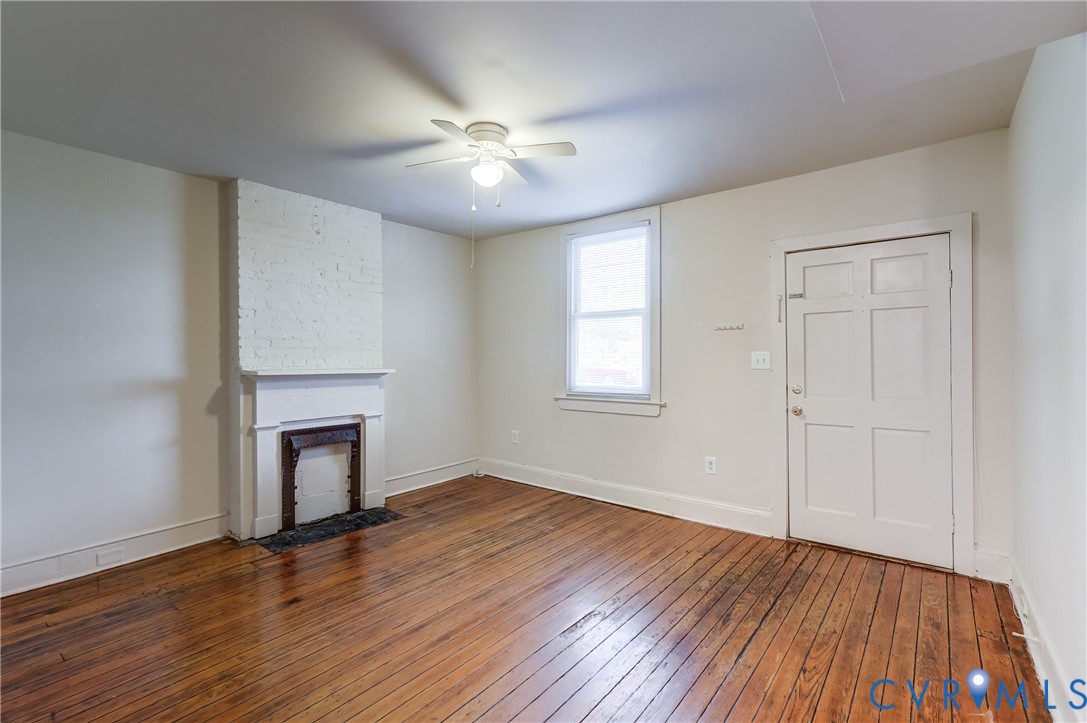 818 Spring Street Richmond, VA 23220 - Photo 6 of 28 a view of an empty room with wooden floor and a window