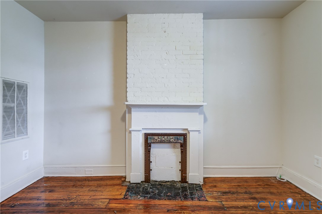 818 Spring Street Richmond, VA 23220 - Photo 7 of 28 a view of room with wooden floor and a fireplace