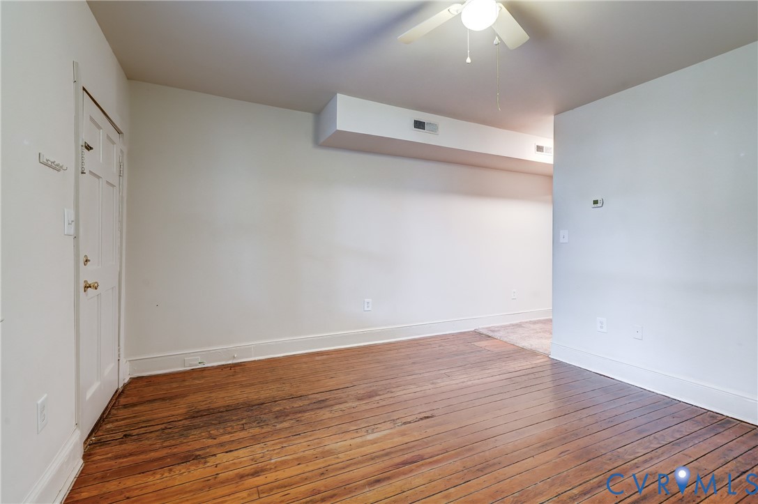 818 Spring Street Richmond, VA 23220 - Photo 8 of 28 a view of an empty room with wooden floor