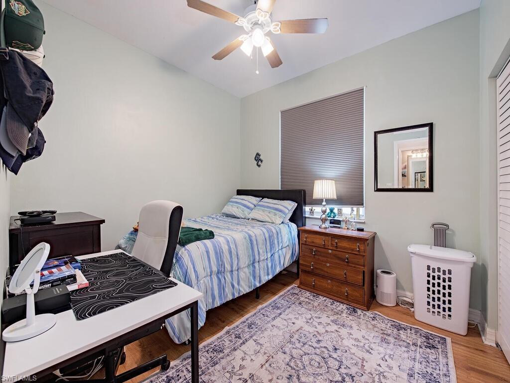 2346 Butterfly Palm Drive Naples, FL 34119 - Photo 12 of 45 Bedroom featuring light wood finished floors and a ceiling fan