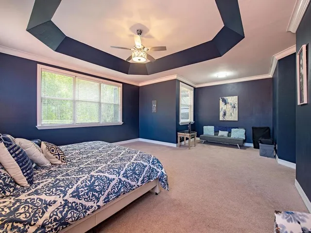 a bed room with a bed and a chandelier