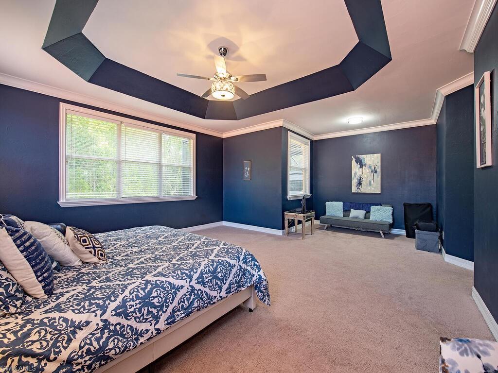2346 Butterfly Palm Drive Naples, FL 34119 - Photo 15 of 45 Bedroom featuring a raised ceiling, crown molding, carpet floors, and ceiling fan