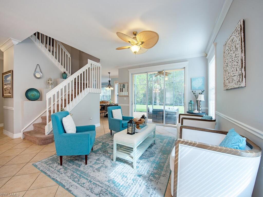 2346 Butterfly Palm Drive Naples, FL 34119 - Photo 4 of 45 Living area with ornamental molding, tile patterned flooring, healthy amount of natural light, and stairs
