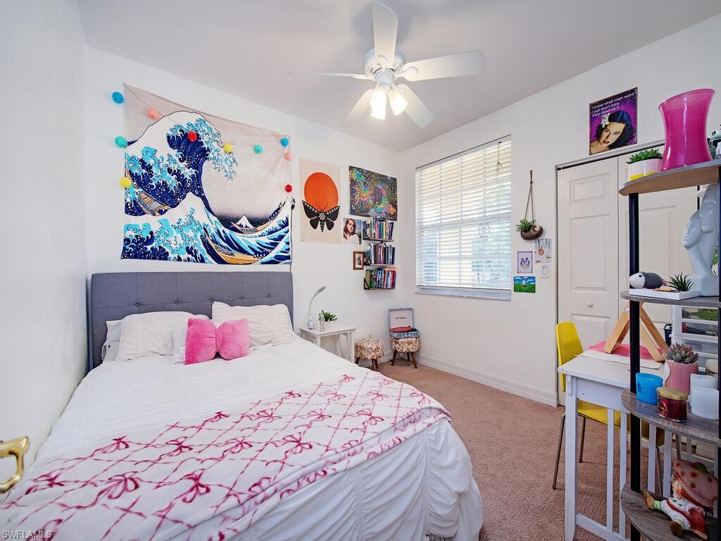 2346 Butterfly Palm Drive Naples, FL 34119 - Photo 10 of 45 Bedroom with light carpet and ceiling fan