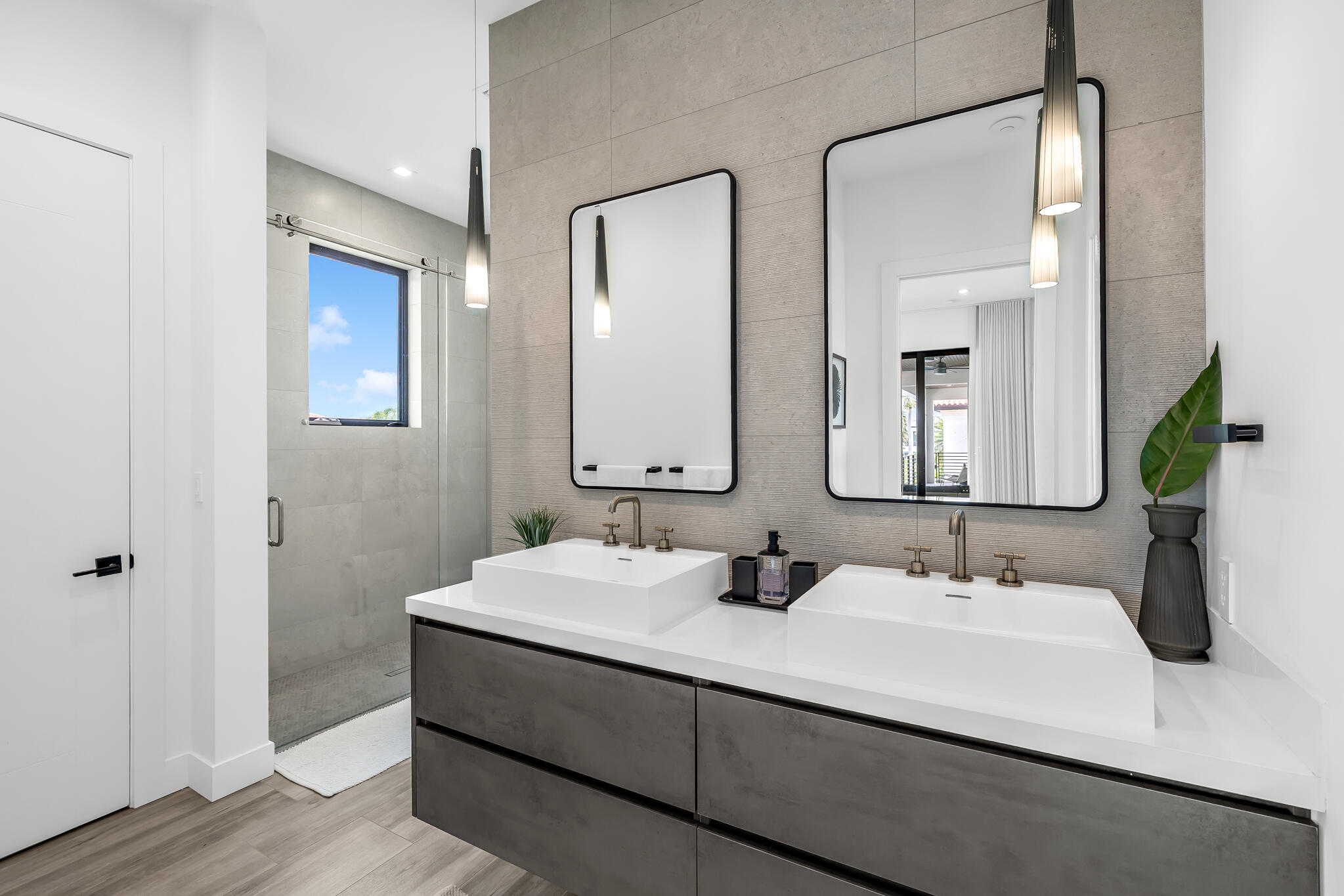 3711 Northeast 30th Avenue Lighthouse Point, FL 33064 - Photo 53 of 57 a bathroom with double vanity sinks and a mirror