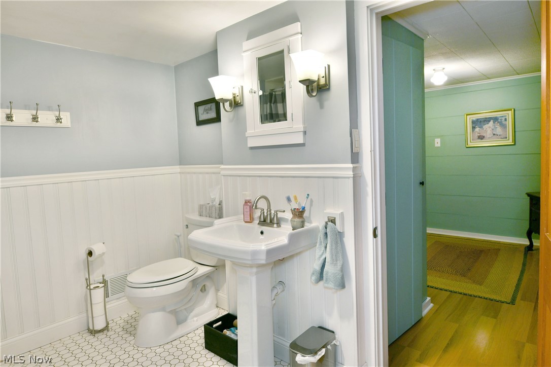 8683 King Graves Road Northeast Warren, OH 44484 - Photo 37 of 50 Bathroom featuring a pedestal sink, toilet, and hexagonal floor tiles