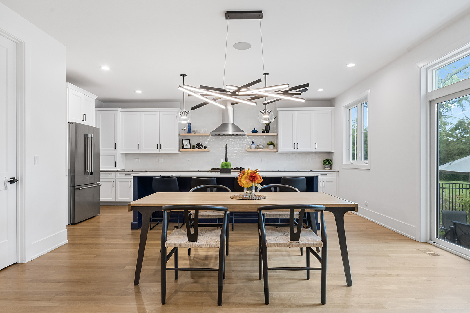 1435 Pfingsten Road Northbrook, IL 60062 - Photo 5 of 17 a kitchen with stainless steel appliances kitchen island a table chairs sink and cabinets