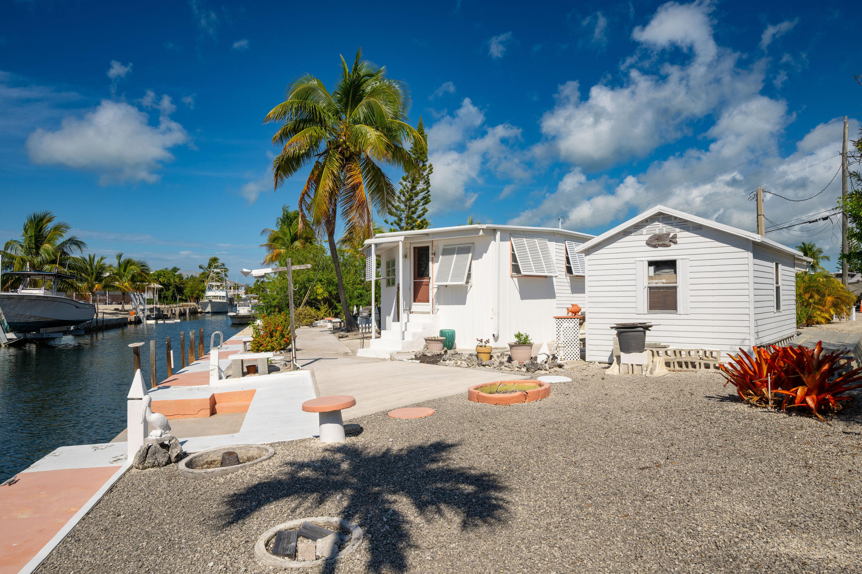 138 Sea Lane Key West, FL 33040 - Photo 31 of 31 a row of palm trees and swimming pool in the backyard of a house