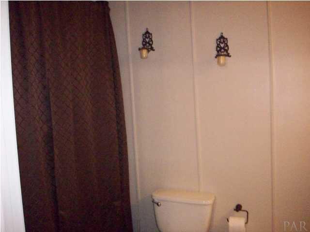 3900 Macks Road Century, FL 32535 - Photo 17 of 24 a white toilet sitting next to a shower