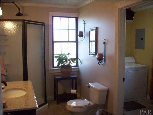 3900 Macks Road Century, FL 32535 - Photo 18 of 24 a bathroom with a toilet a sink and a mirror