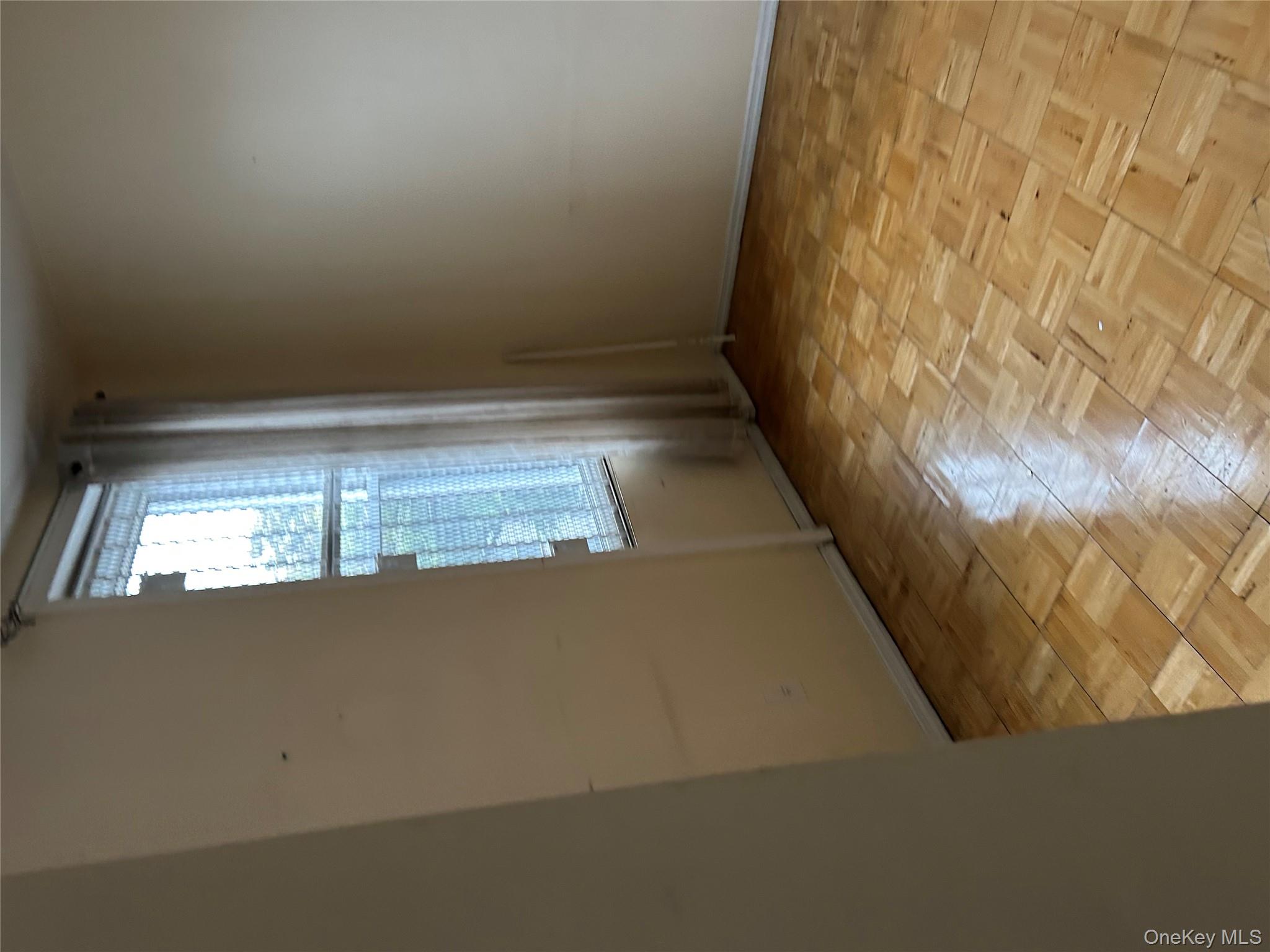 1737 Grove Street Queens, NY 11385 - Photo 5 of 6 an empty room with windows