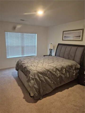 a bedroom with a bed and window