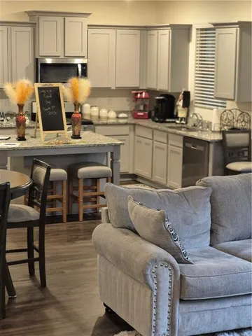 a kitchen with stainless steel appliances granite countertop a sink and a stove