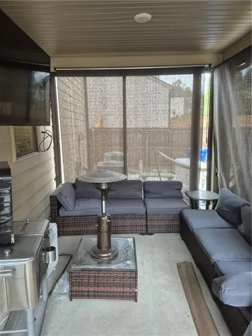 a living room filled with furniture and a floor to ceiling window