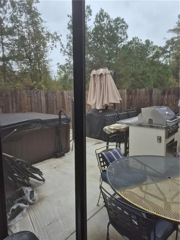 a view of backyard with table and chairs