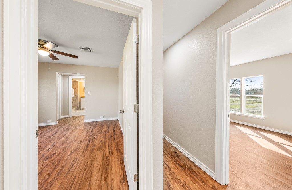 8896 Gholson Road Waco, TX 76705 - Photo 22 of 58 a view of a hallway with wooden floor and a living room