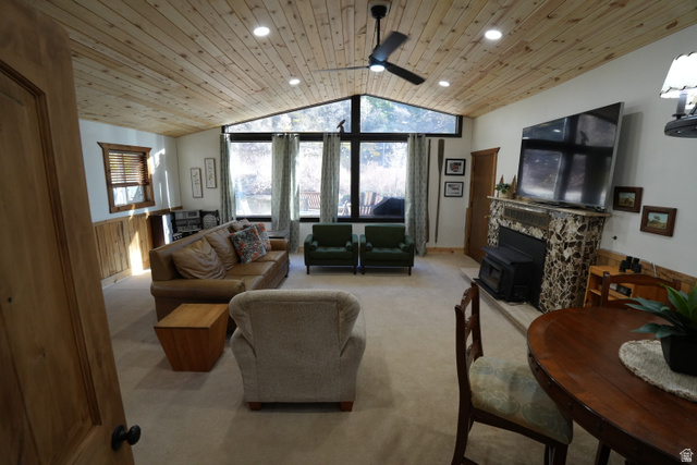3711 North Canyon Road Provo, UT 84604 - Photo 22 of 42 Living area featuring carpet, lofted ceiling, wooden ceiling, plenty of natural light, and wood walls
