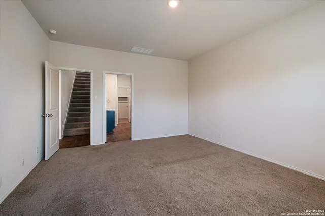 a view of empty room with stairs