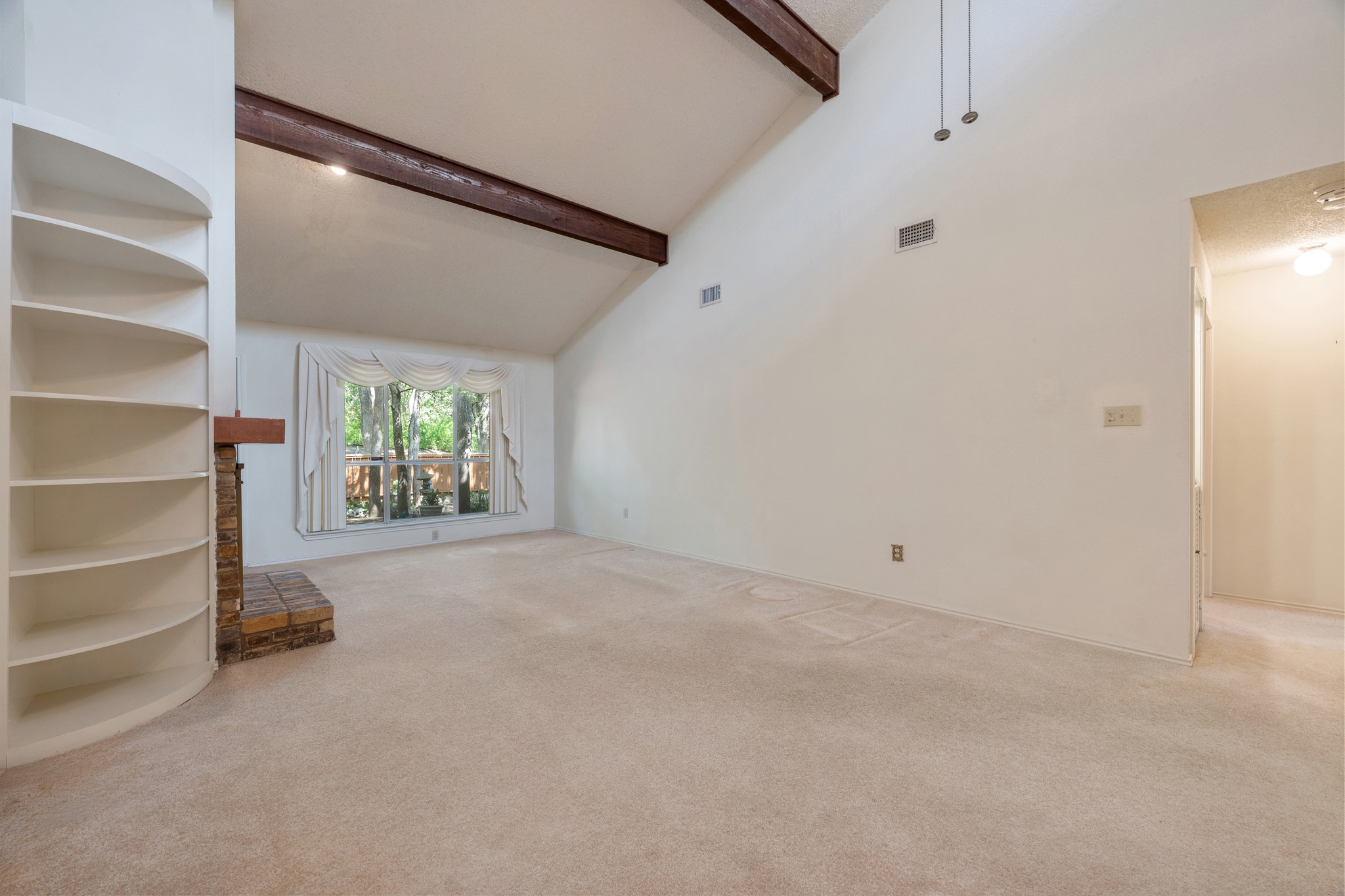 8318 Bent Tree Road Austin, TX 78759 - Photo 20 of 37 Large windows line the living space, flooding the room with natural light and offering direct access to the private backyard