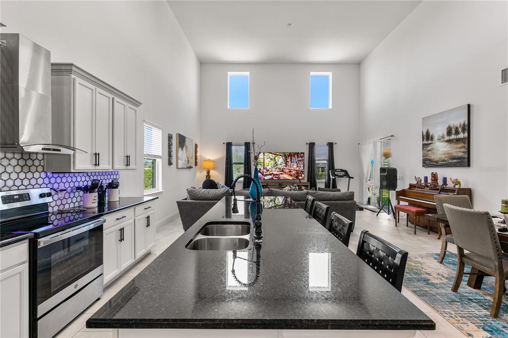 5637 Beggs Road St. Cloud, FL 34771 - Photo 3 of 35 a kitchen with stainless steel appliances granite countertop a lot of counter space