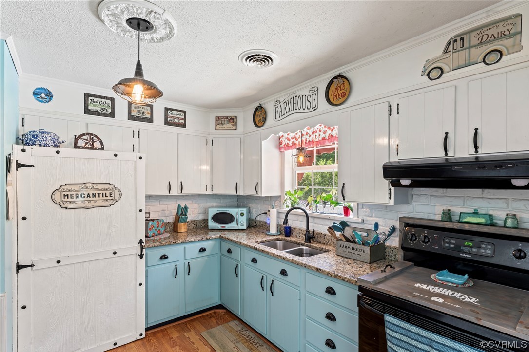 800 Adkins Road Chesterfield, VA 23236 - Photo 5 of 37 a kitchen with a refrigerator and a stove