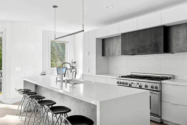 a kitchen with a stove a sink and a refrigerator