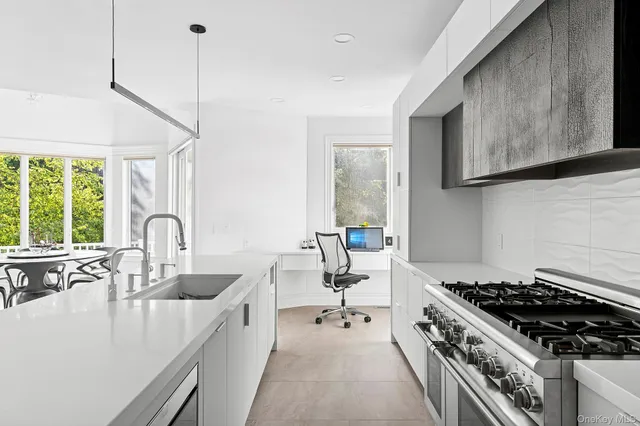 a kitchen with sink stove and cabinets