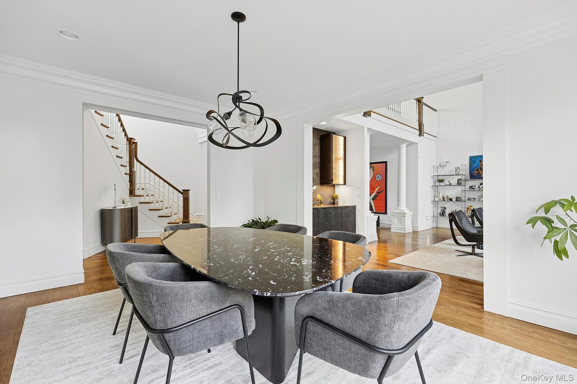 144 Round Swamp Road Huntington, NY 11743 - Photo 16 of 39 a view of a dining room with furniture a chandelier and wooden floor