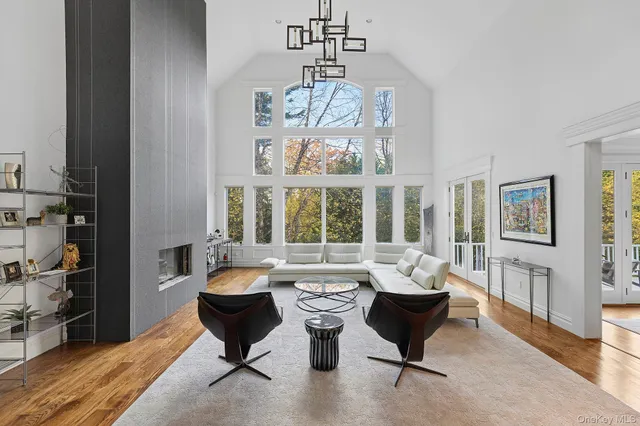 a living room with furniture and a chandelier