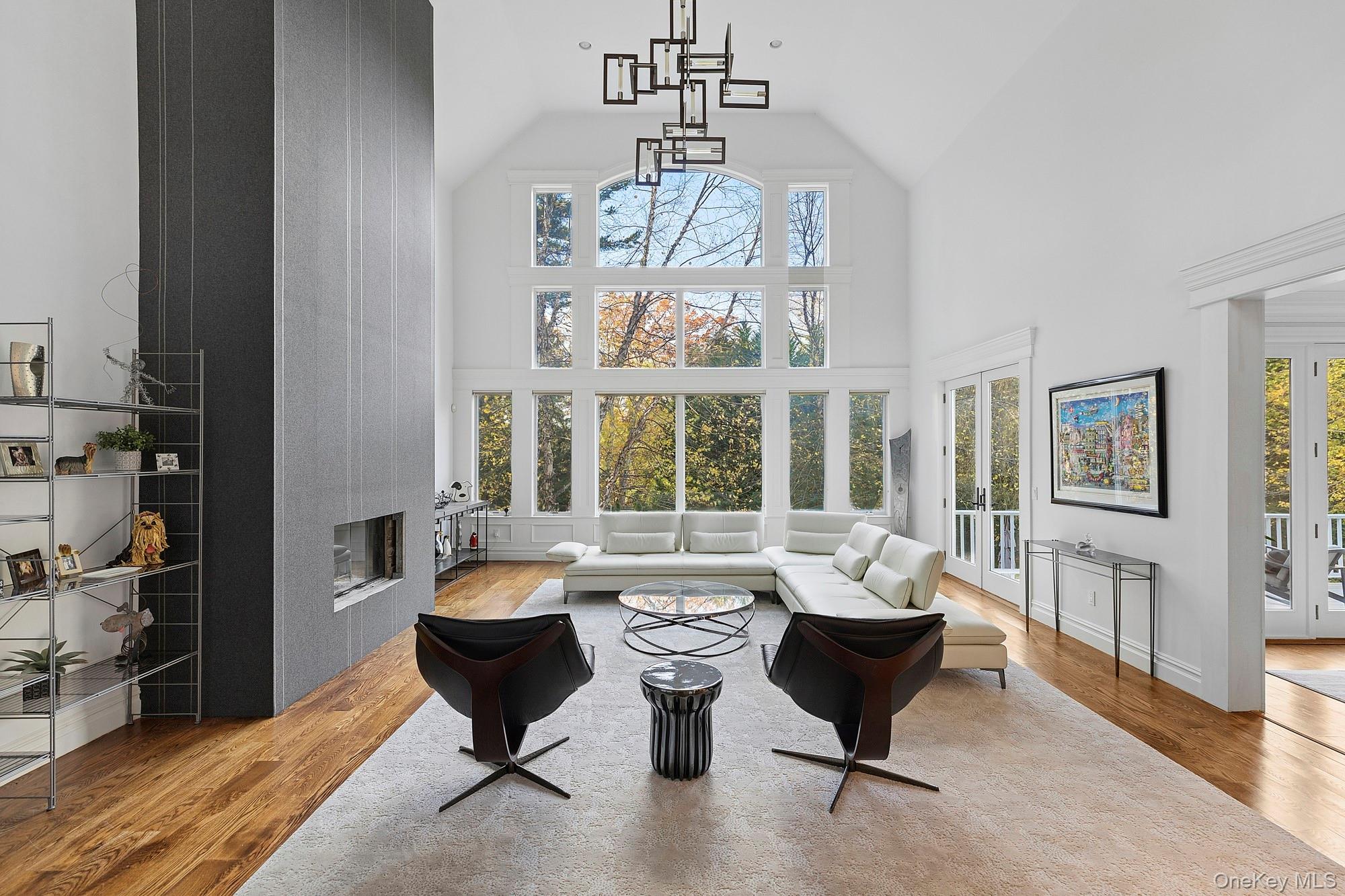 144 Round Swamp Road Huntington, NY 11743 - Photo 2 of 39 a living room with furniture and a chandelier