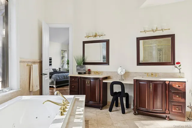 a spacious bathroom with a double vanity sink and a bathtub