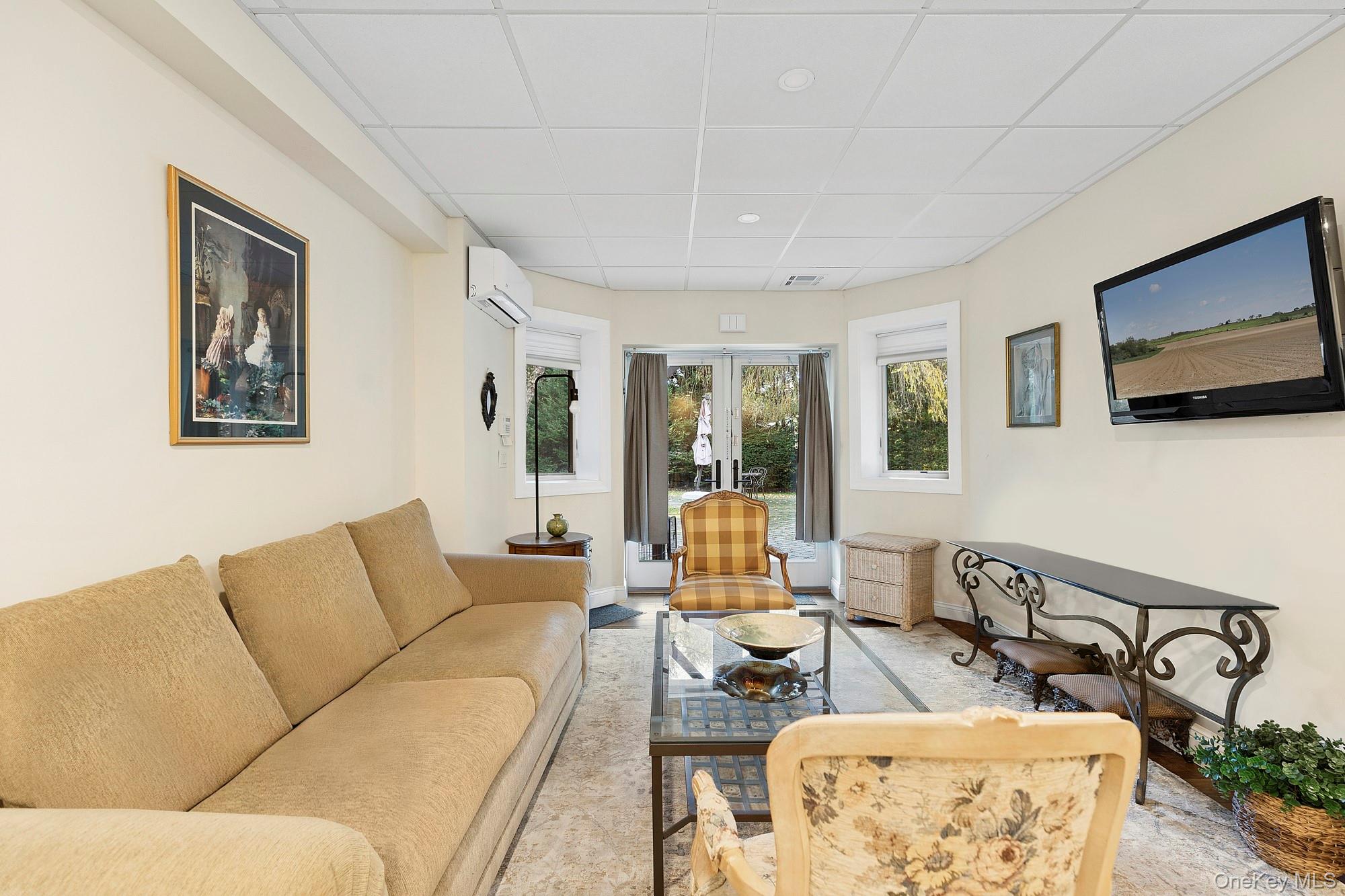 144 Round Swamp Road Huntington, NY 11743 - Photo 37 of 39 a living room with furniture and a flat screen tv