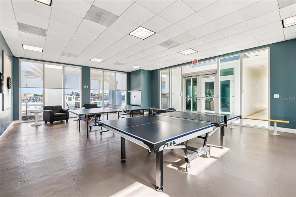 241 Riverside Drive, Unit 305 Daytona Beach, FL 32117 - Photo 27 of 35 a kitchen with counter top a dining table and chairs