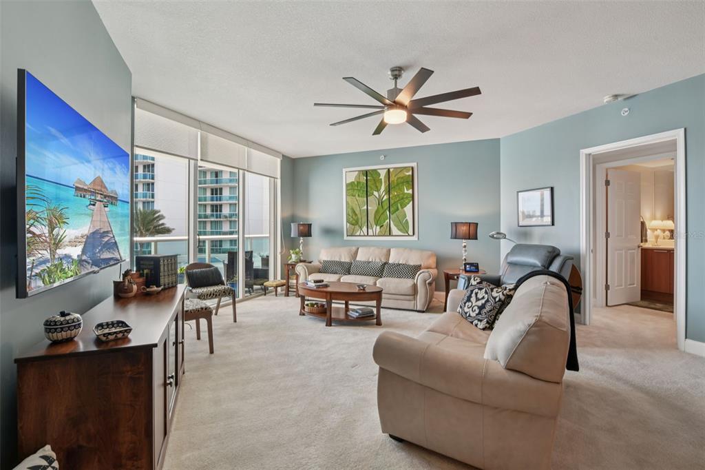 241 Riverside Drive, Unit 305 Daytona Beach, FL 32117 - Photo 4 of 35 a living room with furniture and a flat screen tv