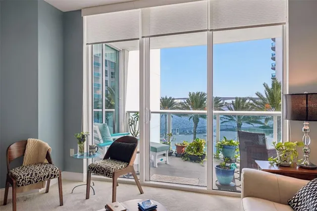 a living room with furniture and a floor to ceiling window