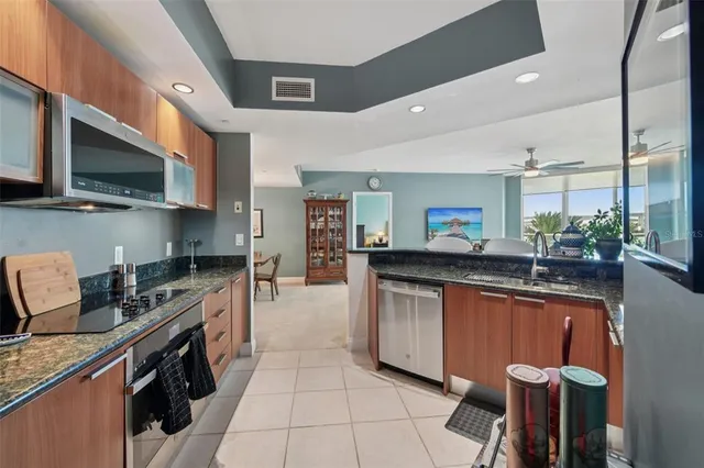 a kitchen with stainless steel appliances granite countertop a sink and a stove