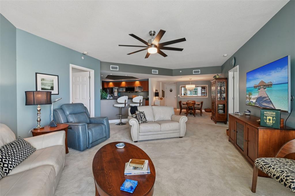 241 Riverside Drive, Unit 305 Daytona Beach, FL 32117 - Photo 10 of 35 a living room with furniture and a flat screen tv