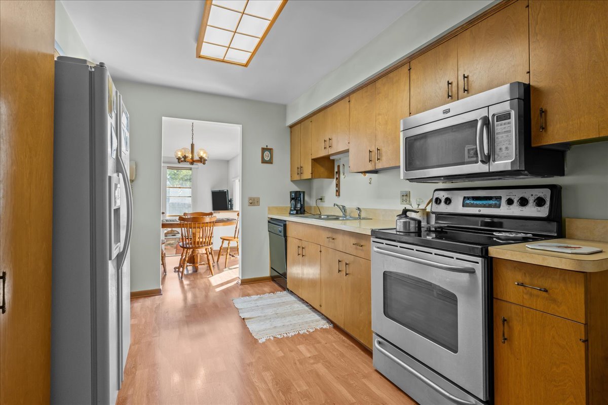328 West State Street North Aurora, IL 60542 - Photo 18 of 31 a kitchen with stainless steel appliances granite countertop a stove a sink and a microwave