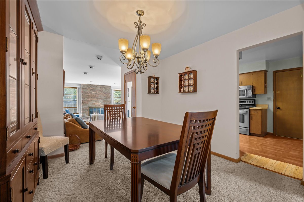 328 West State Street North Aurora, IL 60542 - Photo 8 of 31 a view of a dining room with furniture and a chandelier