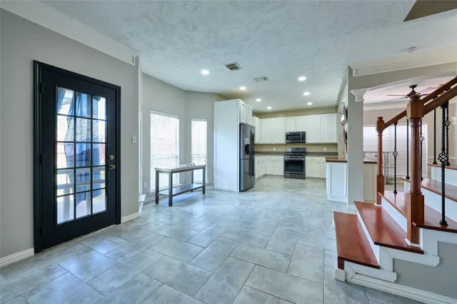 a view of kitchen with furniture and windows