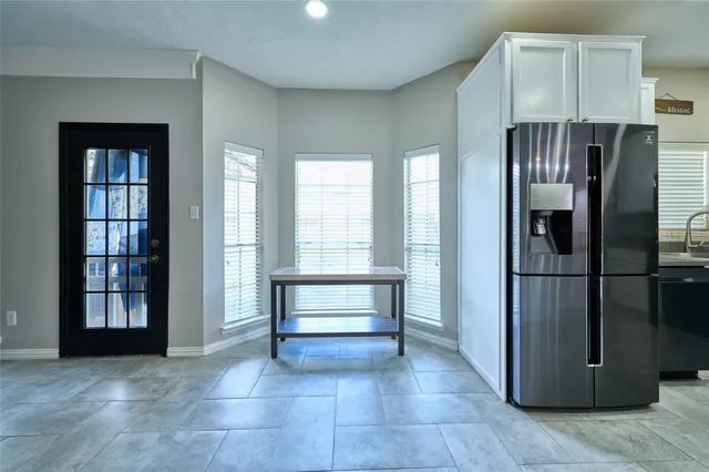 a kitchen with a refrigerator and cabinet