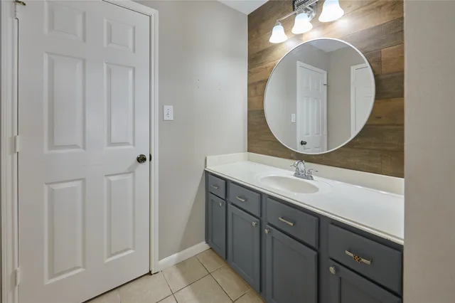a bathroom with a double vanity sink and a mirror