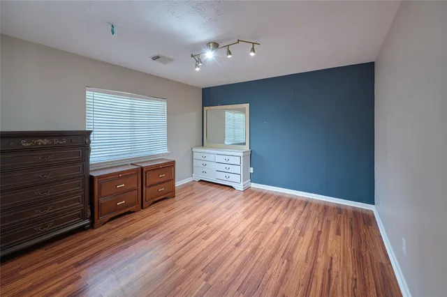 a kitchen with wooden floors and cabinet