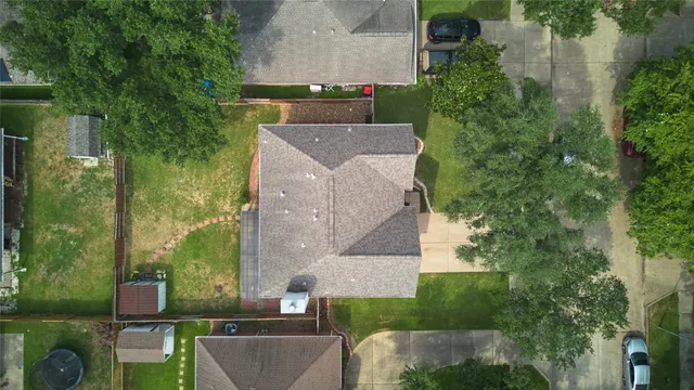 an aerial view of a house with a yard
