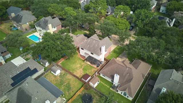 an aerial view of multiple houses with yard