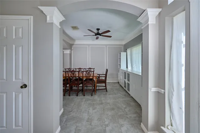 a view of a livingroom with furniture and chandelier fan