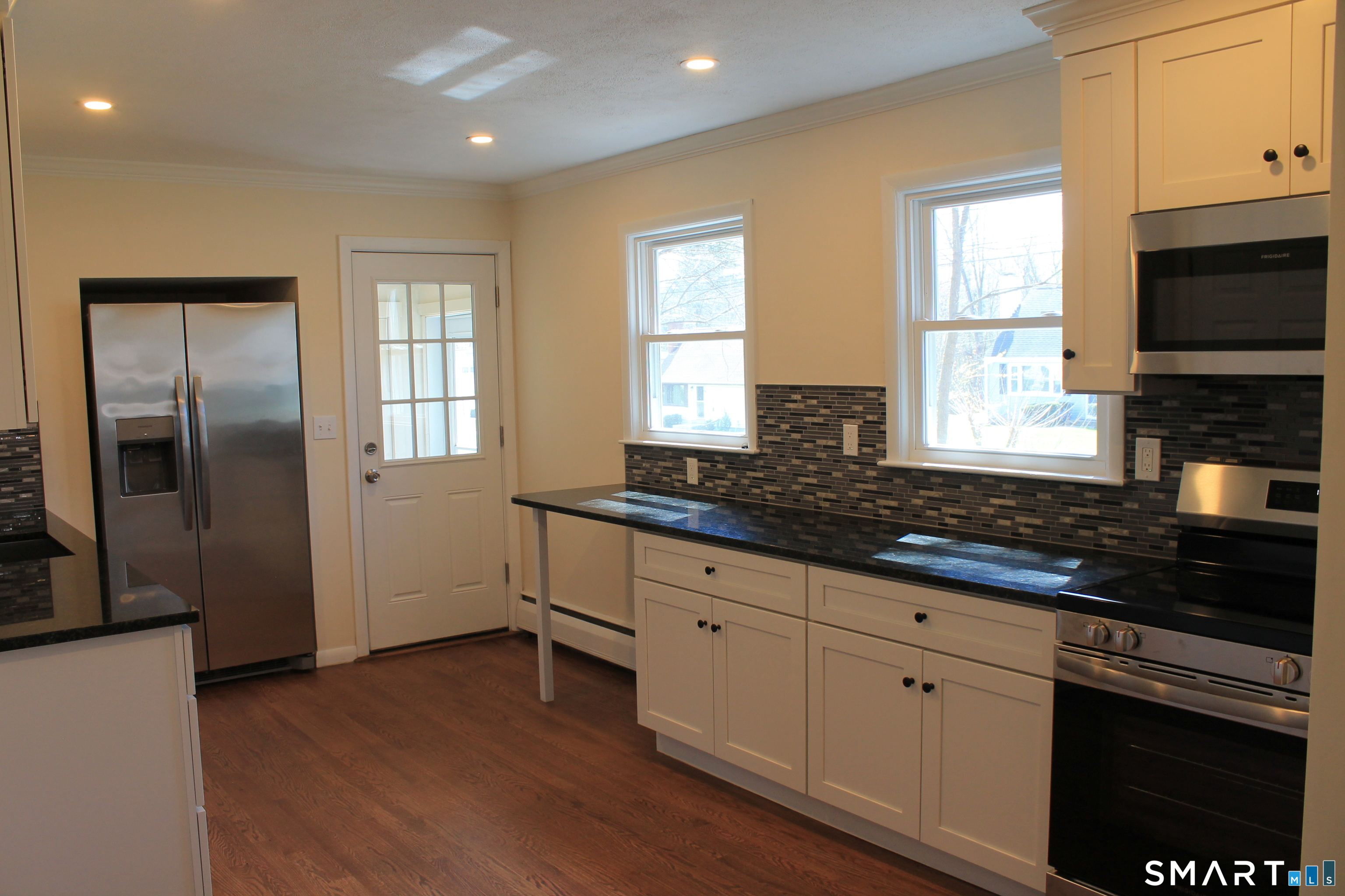 134 Sunset Street Windsor Locks, CT 06096 - Photo 5 of 23 a kitchen with granite countertop a stove a sink and a microwave