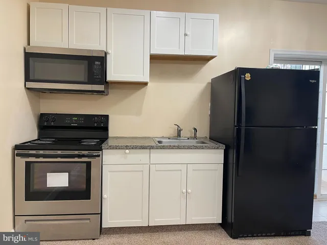 a kitchen with a stove microwave and refrigerator
